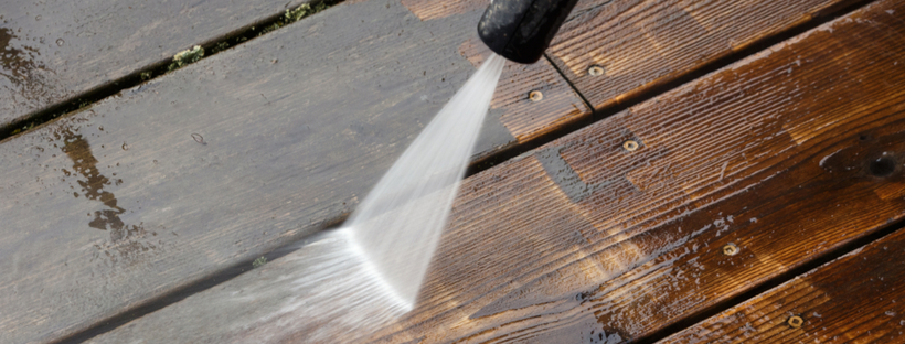 Cleaning wooden deck with water spray