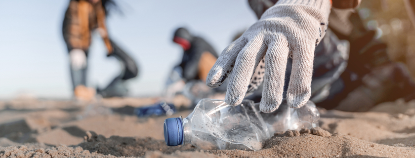 Volunteer collecting trash on a beach