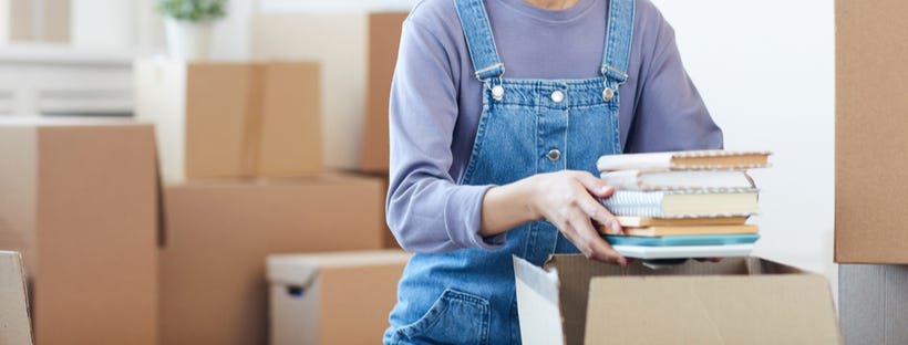 Woman packing books in a box