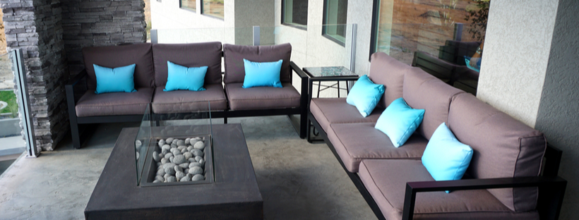Outdoor sofas placed around a fire pit table