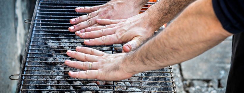 Checking bbq temperature with hands
