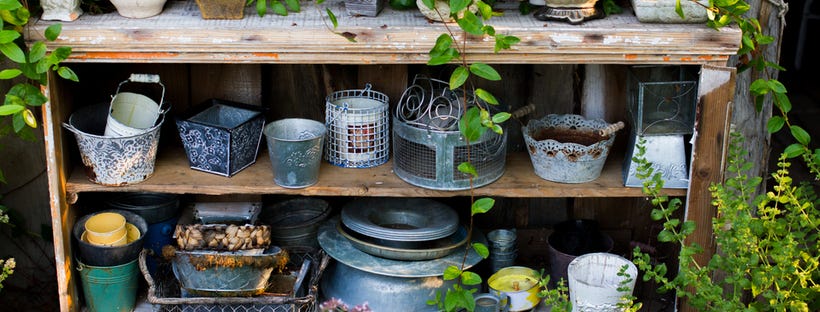 Empty flowerpots arranged on shelves