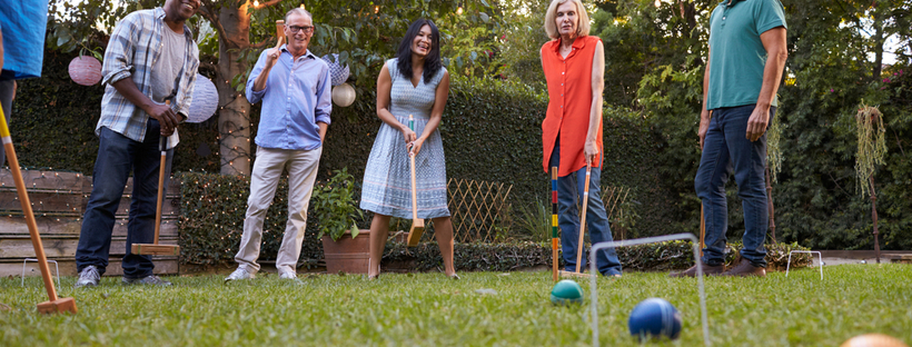 Friends playing croquet in the backyard